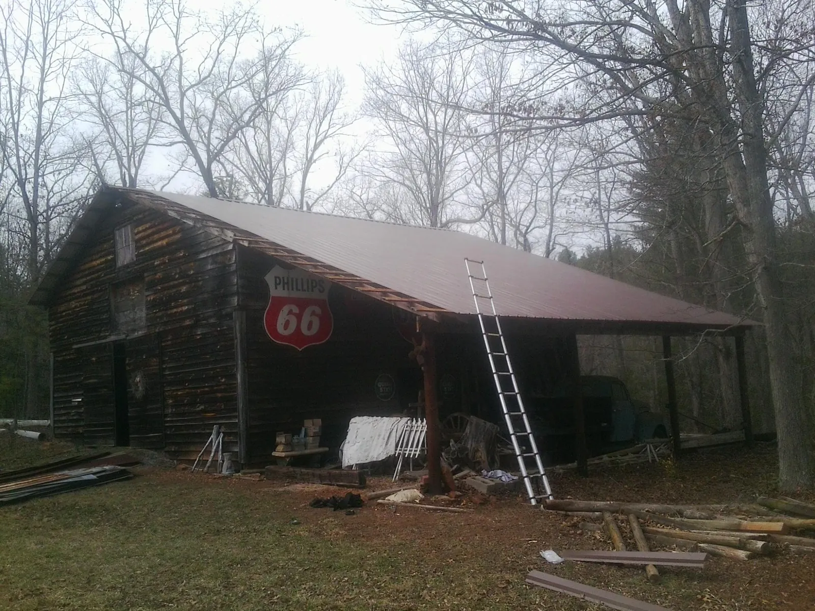 New metal roof on an open sided timber barn with a vintage sign in Clint